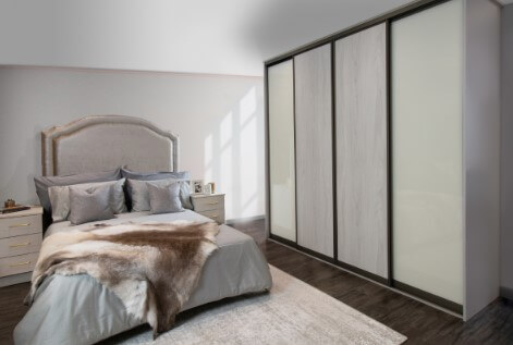 woodgrain sliding wardrobe with bed in background