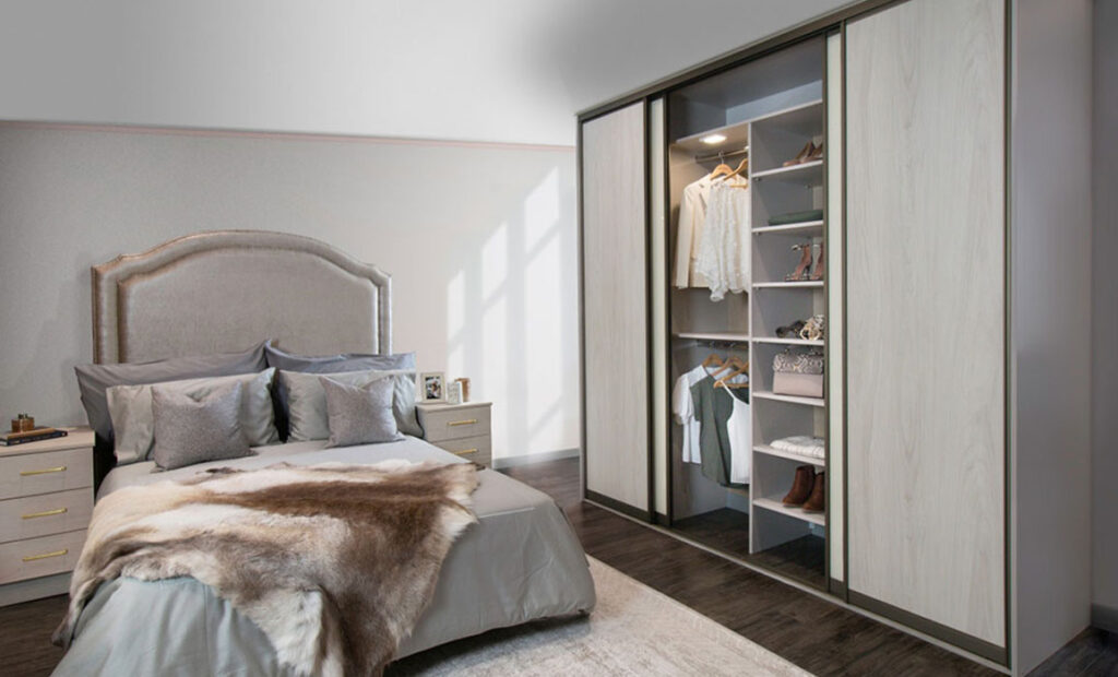 woodgrain sliding wardrobe with bed in background