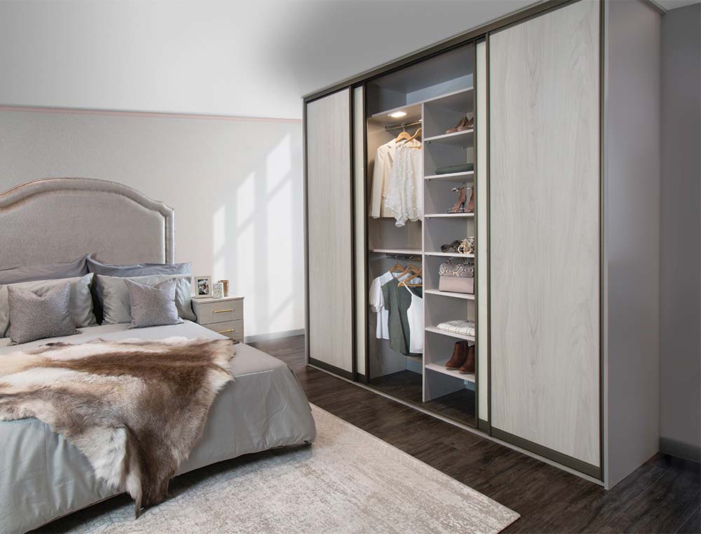 woodgrain wardrobe opened with clothes inside